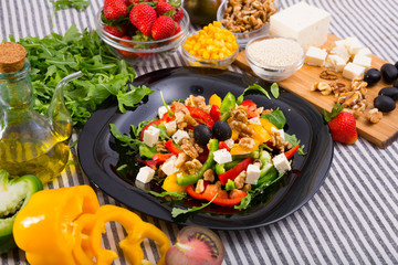 Plate with ready-made salad and its ingredients for recipe