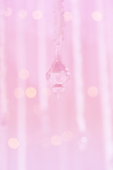 Abstract blurred background of pink curtain and crystal with light bulb bokeh.