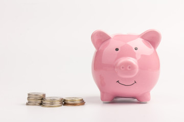 Piggy bank with coin pile on white background, space for text. Finance, saving money