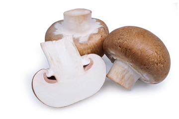 Fototapeta na wymiar Fresh and one cut champignon mushrooms isolated on white background with clipping path. 