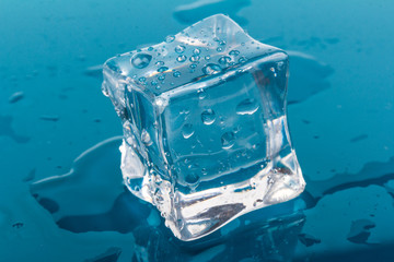 ice cubes and water drops close up on blue background