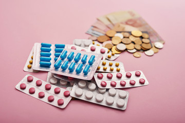 Money and pills. Pills of different colors on money, medicine concept, cash. Heap of various pills. Coronovirus, quarantine, epidemic, pandemic, flu, cold,illness. Medicine concept and health.