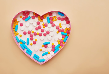 Assorted pharmaceutical medicine pills, tablets and capsules on beige background. Heap of various pills. Coronovirus, quarantine, epidemic, pandemic, flu, cold,illness. Medicine concept and health