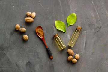 Nutmeg oil - perfume ingredient - on grey background top-down