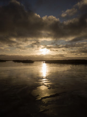 Sunset at frozen lake