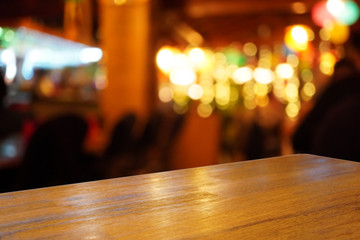 Brown empty wooden table top in front of blurred background. Light wood with blurry in restaurant interior. Can be used for display or montage your products. Mock up for display or product.