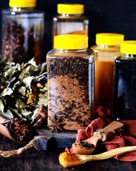Mix of spices on a dark wooden background.