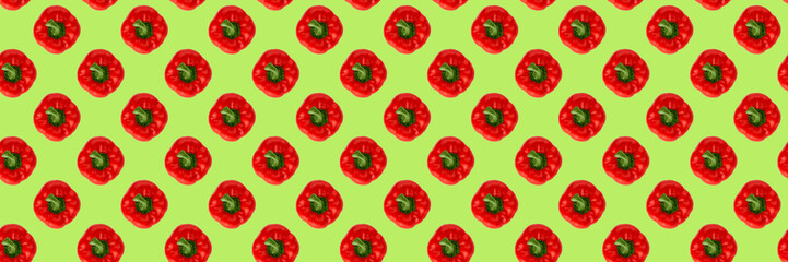 Seamless food pattern. Red sweet bell pepper on a green background. Organic vegetable, healthy ingredient.