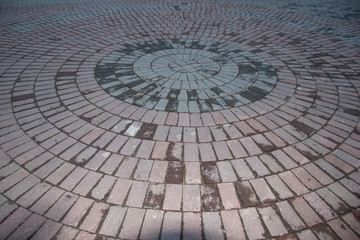The colored tiles are arranged in a circle. The colors are gray and pinkish.
