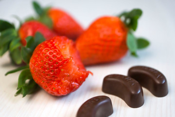 Fresh, ripe, beautiful, strawberries. Chocolate candies and strawberries view from the top.