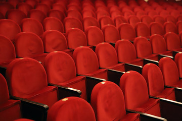Classic rows of empty reddish seats in theatre