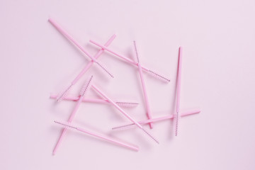 Pink eyelash brushes on a pink background