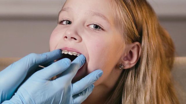 Portrait of a little girl who has a professional dentist insert an orthodontic plate to correct her bite. Healthy, beautiful smile, children's dentistry