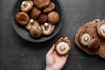 Fresh Raw Shiitake mushrooms on a dark background