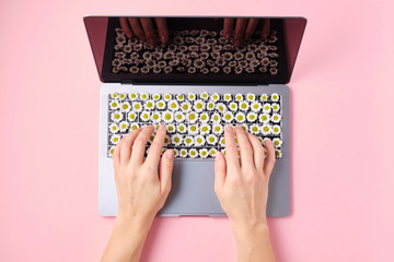 Spring Flowers Keyboard. Laptop with Flowers over pink backgroun