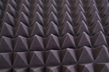 The pattern of the soundproof panel of polyurethane foam. black geometric background