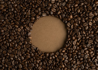 Coffee background and circle without coffee in the center of the frame. Flat lay
