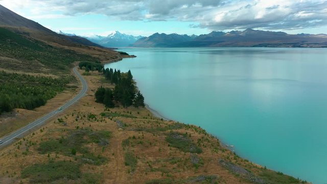 Amazing scenic windy road with mountains and glacier lake, aerial view. MT Cook State Highway 80, New Zealand.