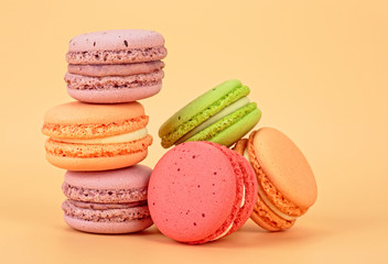 Sweet and colourful french macaroons on colored background