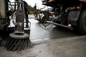 Brushes for cleaning the streets are fixed on the car. Special machinery. Machine with tassels. Car for cleaning in the city. Automatic road cleaning brushes. Washing sidewalks.