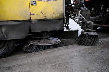 Brushes for cleaning the streets are fixed on the car. Special machinery. Machine with tassels. Car...