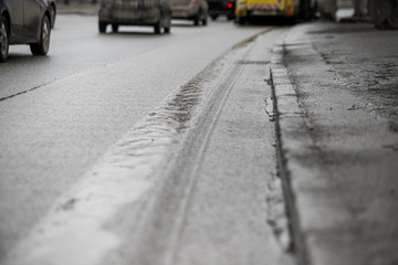 Road pits in the city in the spring after the snow melts. Problem of roads and asphalt in the city.
