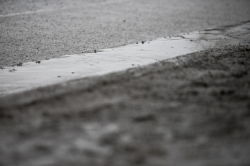 Road pits in the city in the spring after the snow melts. Problem of roads and asphalt in the city.