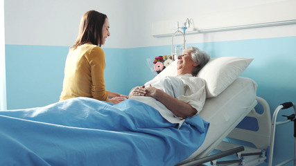 Young woman visiting her grandmother at the hospital