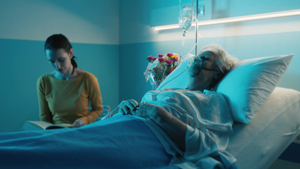Woman assisting a senior patient at the hospital