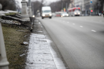 Spring, snow melting. Dirty, wet and slippery pedestrian walkways and city roads