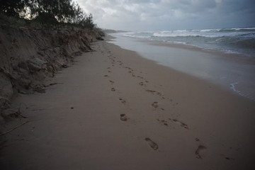 Feet traces on the sandy beach