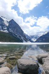 Mount fairview, partly frozen lake, rocks in foreground. Lake Louise Banff National Park, Alberta Canada
