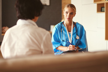 Fototapeta premium Female patient and doctor have consultation in hospital room
