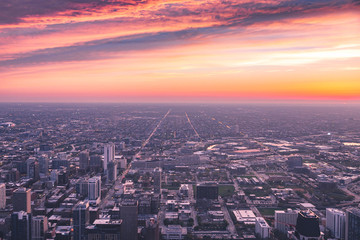 Fototapeta na wymiar Panoramic view of Chicago city from downtown during a vibrant sunset with roads and building lights 