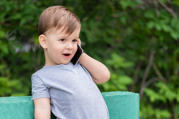 beautiful baby speaks on the phone on the street