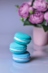 Fototapeta na wymiar stack of blue macaroons on white background with copy space for text
