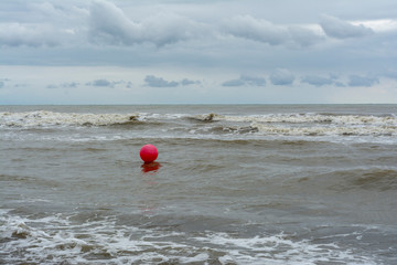 red ball on the waves of sea