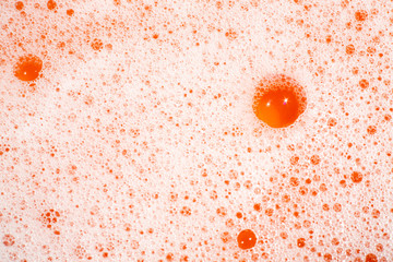 Bubble Soapsuds transparent foam with water on orange background, Close up & Macro shot, Selective...