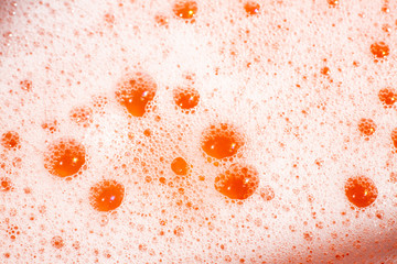 Bubble Soapsuds transparent foam with water on orange background, Close up & Macro shot, Selective...