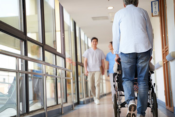 employee and residents walking in hallway of nursing home