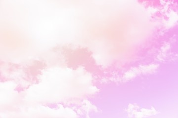 Fototapeta premium Sunny pink sky background. Beautiful warm sky with clouds. Toned photo