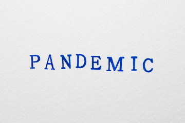 Fototapeta na wymiar a pandemic word stamped on a piece of paper.