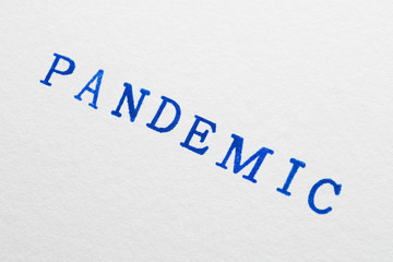 a pandemic word stamped on a piece of paper.