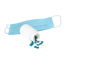white plastic container with pills and medical protective mask isolated on white background