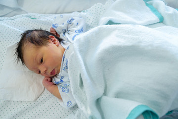 Bebé recién nacido en cuna de hospital