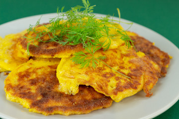Keto recipe. Cream cheese pancakes. On a green background.