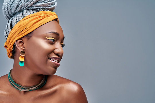 Side View Of Young Fashion African Woman Wearing Headscarf On Grey Background