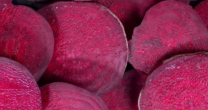 Rotating fresh beets slices . Top view.