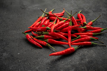 pile of Red chili peppers on a black stone