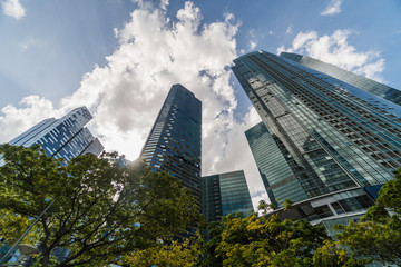 Fototapeta premium Looking up in Singapore at tall buildings, one of the most developed parts of Asia